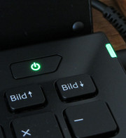 The power button, and the power indicator both shine green.