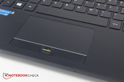 The touchpad has physical buttons and a fingerprint reader located in the middle