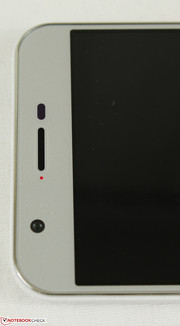 Ambient light sensor adjacent to earpiece and status light
