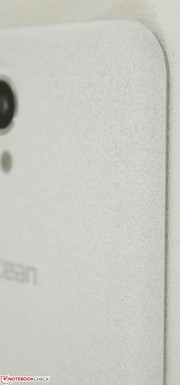 Sandstone back cover feels better than plastic, but not as sturdy as alloy