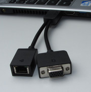 A dongle provides VGA and Gigabit Ethernet connectivity.