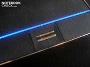 A thin illuminated strip marks the bottom of the touchpad.