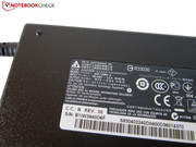 A 120 W power adapter charges the laptop.