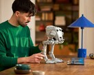A man looking at an AT-ST Walker model. (Image source: LEGO)