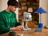 A man looking at an AT-ST Walker model. (Image source: LEGO)