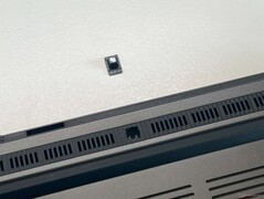 Two hidden screws under glued-on rubber feet