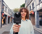 Woman walks on the street filming with the Portalcam