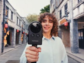 Woman walks on the street filming with the Portalcam