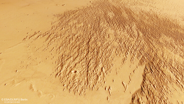 A image of sandblasted scratches near Mars’s Eumenides Dorsum mountains (Image source: ESA, DLR, and FU Berlin; cropped)