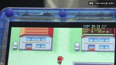 Close-up of the transparent-blue FPGBA SP handheld running Pokémon, with a 59.74 FPS counter visible.