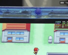 Close-up of the transparent-blue FPGBA SP handheld running Pokémon, with a 59.74 FPS counter visible.