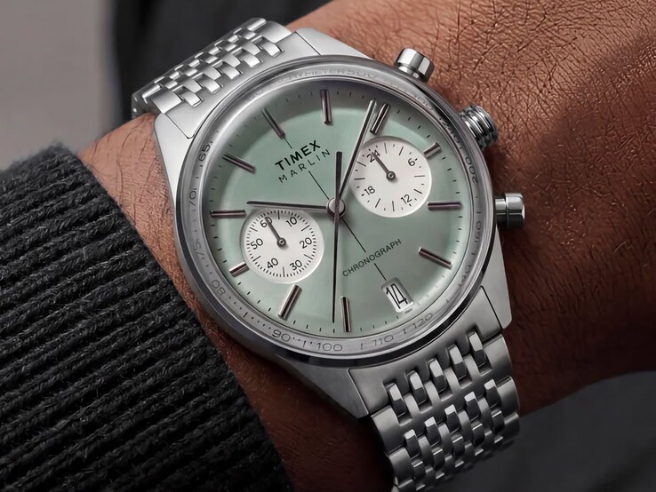 Timex Marlin Jet Chronograph with a sage-green dial and stainless-steel bracelet worn on a wrist, showing its domed crystal and rounded retro-futurist case profile.