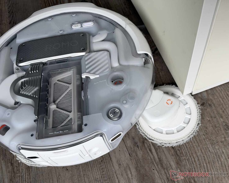 The DJI Romo P2 extends one of its two mop pads particularly far out.