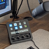 Stream Deck+, connected to a Wave DX, with a PC monitor in the background
