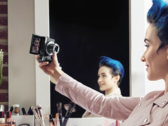 Woman holding Canon PowerShot compact camera