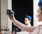 Woman holding Canon PowerShot compact camera