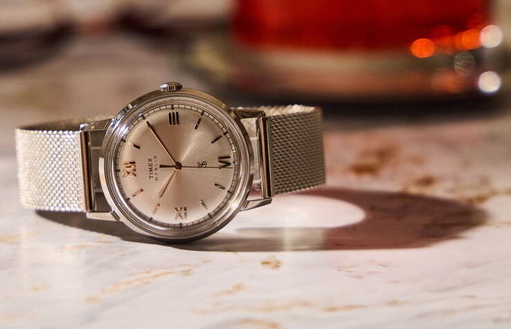 The silver dial variant features a polished stainless steel case, domed acrylic crystal, and matching Milanese mesh bracelet.