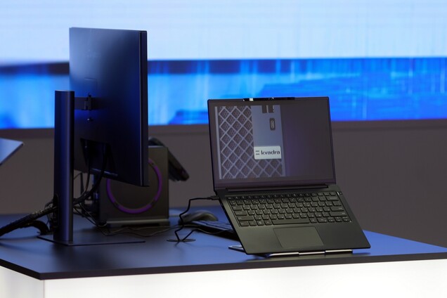 Kvadra NAU LP14 ultrabook shown with the docking station and an external monitor.