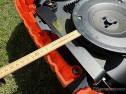 The mower is around 9 cm from the edge