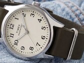Timex Weekender New England TW2Y86500 with a silver-tone case, cream dial, and dark green leather strap.
