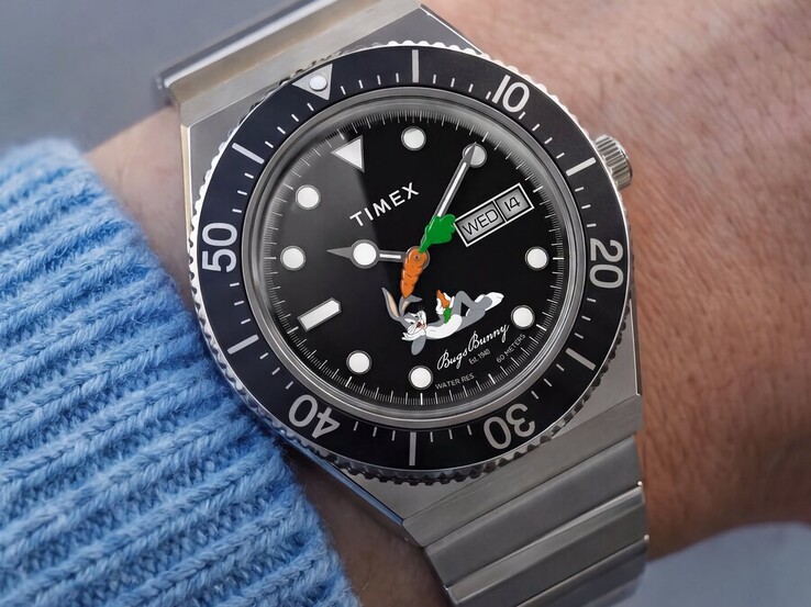 Timex Looney Tunes x M79 Automatic worn on the wrist, showing its black dial with Bugs Bunny, a carrot-shaped seconds hand, day-date display, and black rotating bezel.
