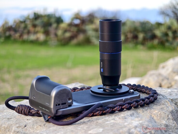 The Vivo X300 Pro fully equipped with a camera grip, teleconverter, and carrying strap. (Image source: Alexander Fagot, Notebookcheck)