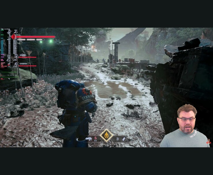 Gameplay scene from Warhammer 40,000 Space Marine 2 with on-screen performance metrics and the YouTuber appearing in the corner during the test. (Image source: The Phawx via YouTube)
