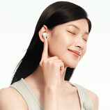 The Redmi Buds 8 costs around $33 in China. Pictured: a promo picture showing the earbuds being worn.