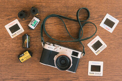 The developer's new feature for Fujfilm cameras will be built into the existing Fujistyle app. Pictured - the Fujfilm X100V camera alongside various film rolls. (Image source: Fuji X Weekly)