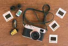The developer&#039;s new feature for Fujfilm cameras will be built into the existing Fujistyle app. Pictured - the Fujfilm X100V camera alongside various film rolls. (Image source: Fuji X Weekly)