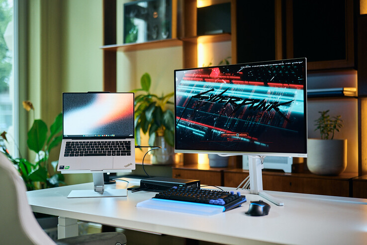 Complete workstation setup featuring a ThinkPad X9 14 laptop on a stand, an Aorus RTX 5060 Ti AI Box eGPU, and an external monitor displaying Cyberpunk 2077.