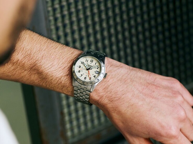 A person looking at a Seiko 5 Sports Field-HDB002 with a beige dial on their wrist.