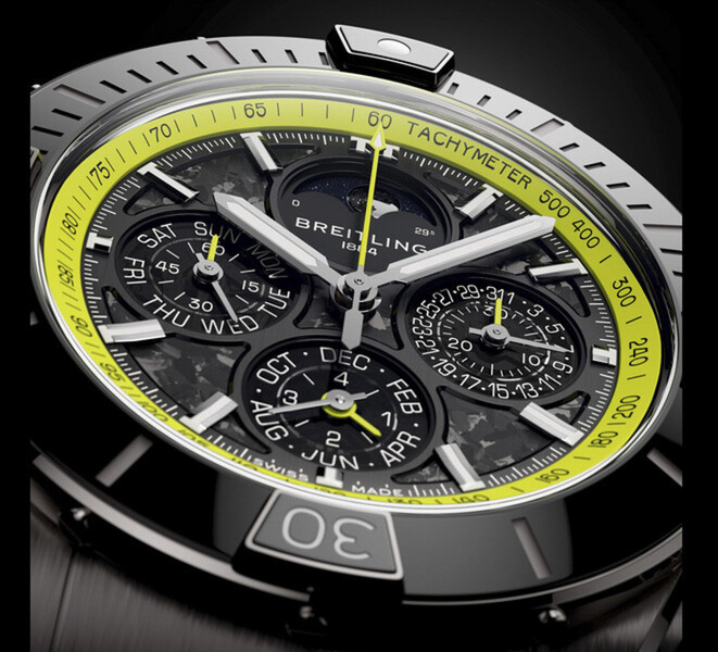 Close-up of the Breitling Super Chronomat B19 44 Perpetual Calendar Chronograph showing its carbon-fibre dial, calendar subdials, silver-tone hands and lime-green tachymeter scale.