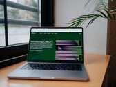 Laptop on a desk by a window with the OpenAI ChatGPT website open on the screen