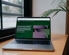 Laptop on a desk by a window with the OpenAI ChatGPT website open on the screen