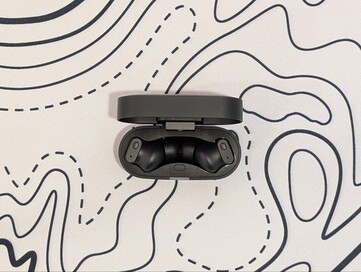 Status Pro X wireless earbuds in their charging case.