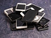 Heap of retired smartphones on a grey surface