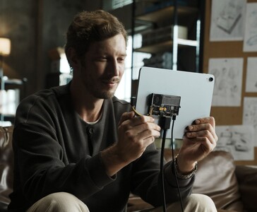 User connecting Sharge Disk Pro transparent portable SSD with active cooling to a tablet via USB-C cable. (Sharge via Kickstarter)