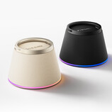 The speaker magnetically clips to the back of a wireless charging phone, including iPhones, and holds it up as a stand.