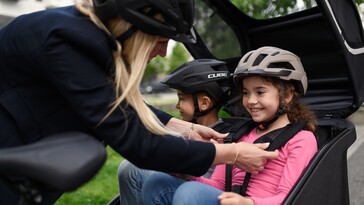 The Cube Trike Family Hybrid can seat two children side-by-side in the covered back seats. (Image source: Cube)