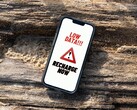 iPhone screen showing a persistent low data recharge warning message. (Image source: Arpit Brandings via Pexels, modified)