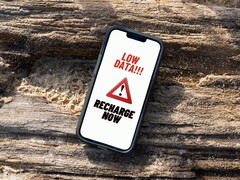 iPhone screen showing a persistent low data recharge warning message. (Image source: Arpit Brandings via Pexels, modified)