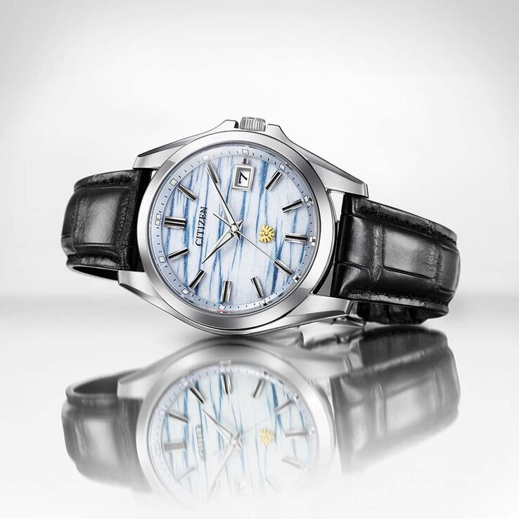 Citizen AQ4090-08A resting on a reflective surface, highlighting its indigo washi paper dial and black leather strap.