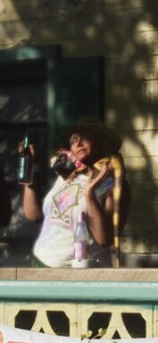 A woman with an iguana on her shoulder that appears to be wearing its own outfit (zoomed-in GTA 6 screenshot).