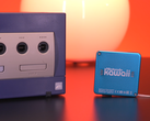 A screengrab showcasing the Nintendo Gamecube next to the tiny keychain-sized Nintendo Kawaii Wii