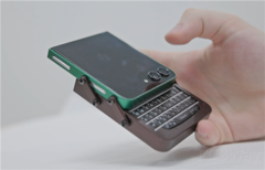 Galaxy Z Flip 5 with a custom case and BlackBerry keyboard in a hand