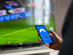 A hand is holding a smartphone with the VPN app open