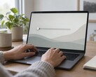 Hands on a laptop keyboard, a slider at the far left on the screen