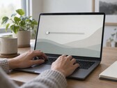 Hands on a laptop keyboard, a slider at the far left on the screen