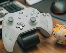 White Xbox controller resting on a wooden desk beside a small cat figurine (Image source: FOX ^.ᆽ.^= ∫ via Pexels)